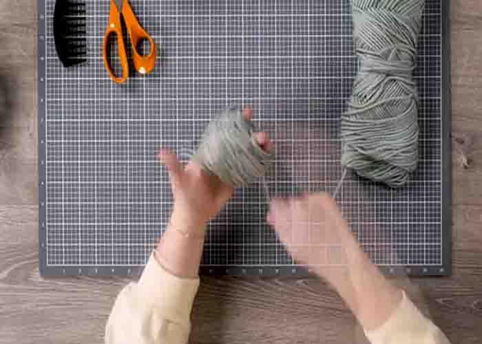 Wrapping the yarn around the finger to make the pom pom