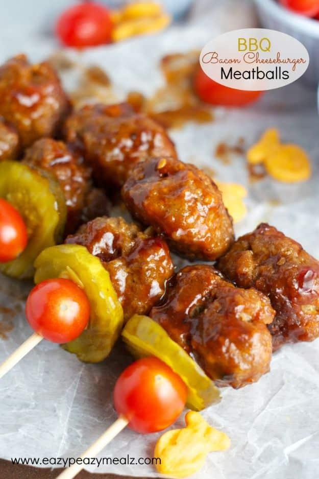 Skewers of barbecue glazed bacon cheeseburger meatballs with pickles and tomatoes under an oval cream name badge