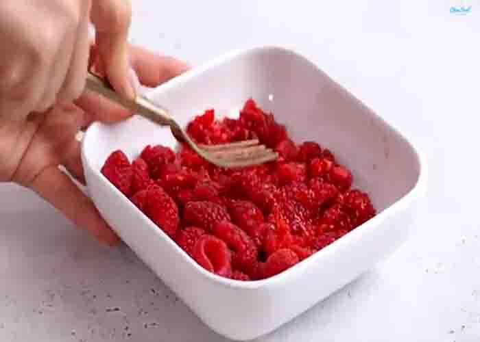 Crushing the raspberries for the chocolate bites