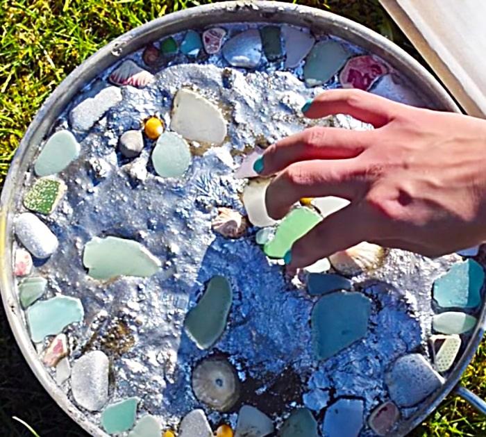 Place sea glass In Wet Concrete To Make A sea Glass Stepping Stone