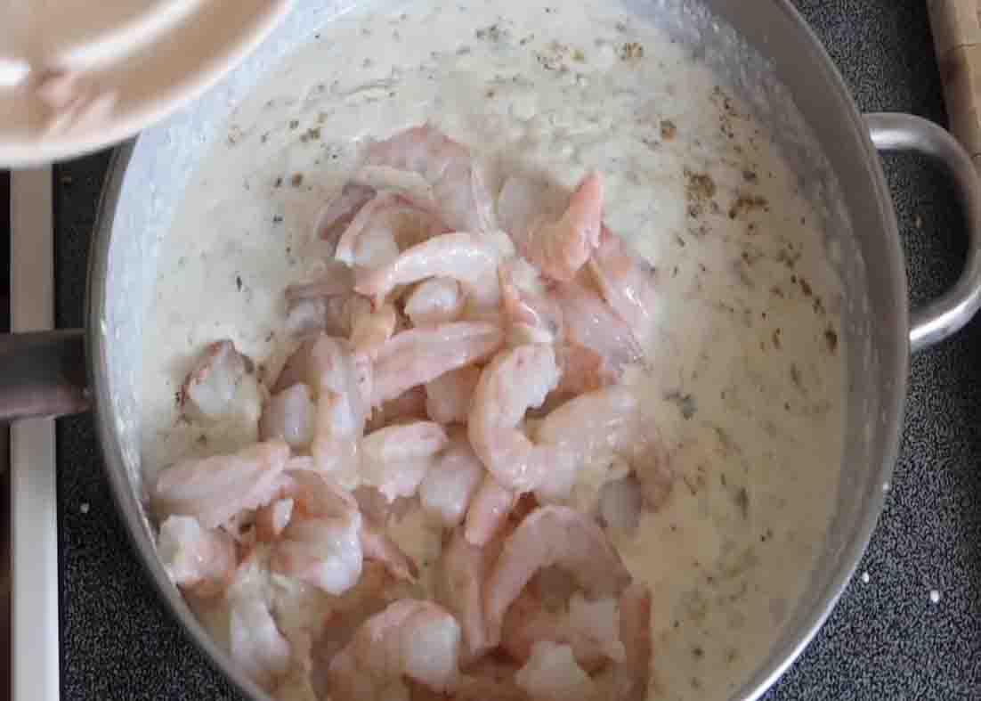 Adding the shrimp and crab meat on the pan
