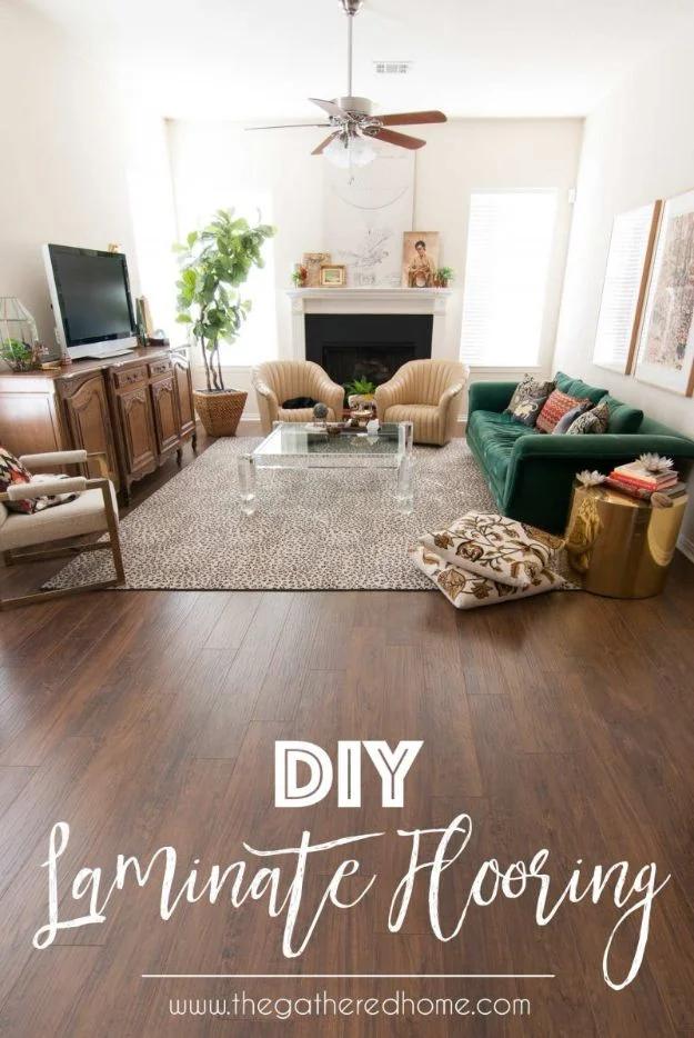 DIY laminate flooring, dark walnut plank floor in a living room with a leopard rug, green velvet sofa and fireplace