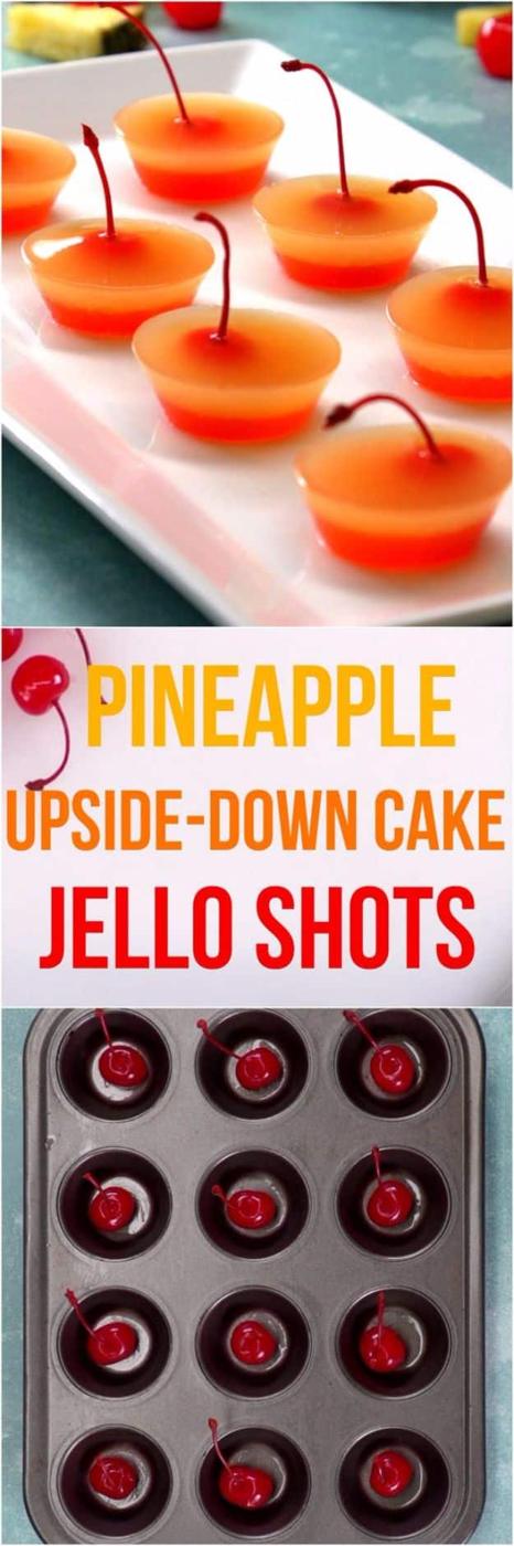 Pineapple upside down cake jello shots in clear cups with a maraschino cherry set at the bottom of each