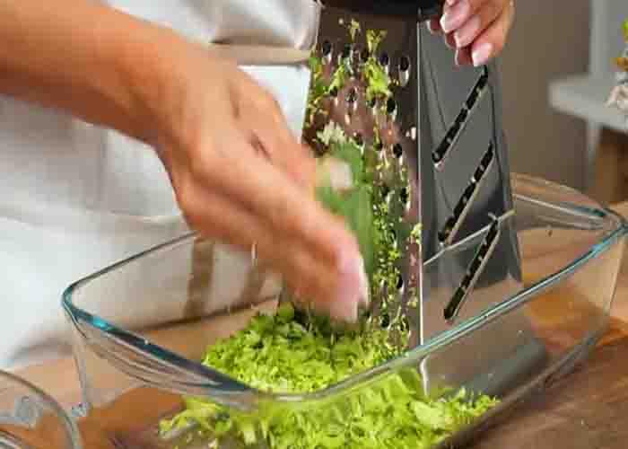 Grating the broccoli for the cheesy broccoli cups