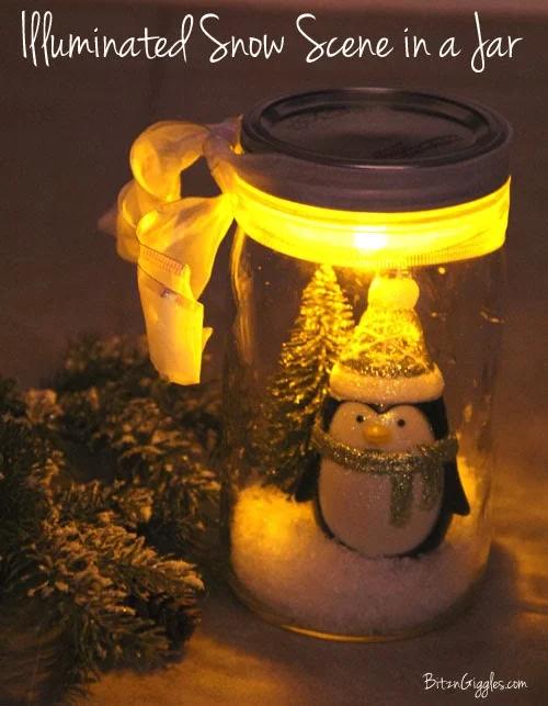A mason jar snow scene with a penguin and a mini tree in faux snow, lit from a tea light under the lid, with a white bow