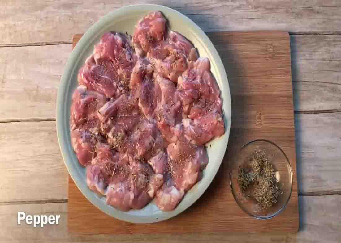 Seasoning the chicken with herbs and spices