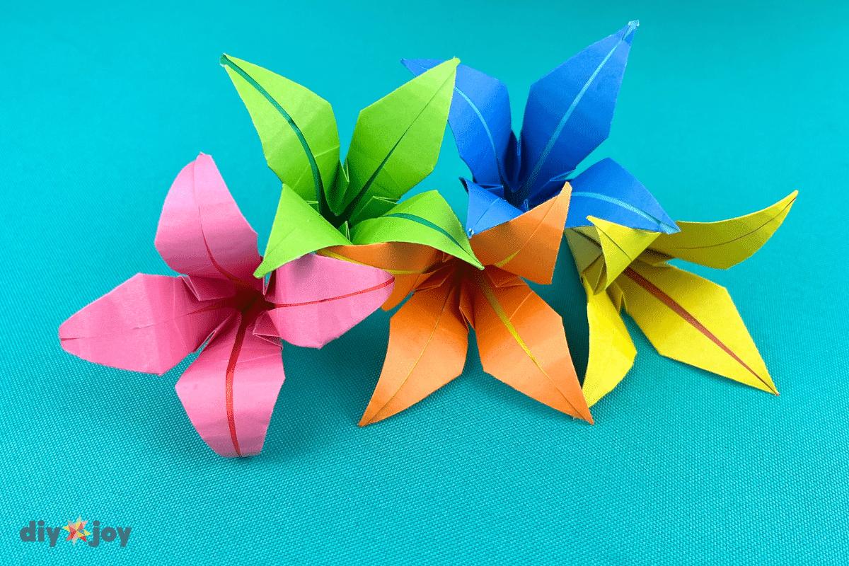 DIY paper flower lily shown finished from above, an origami bloom folded from one square piece of paper