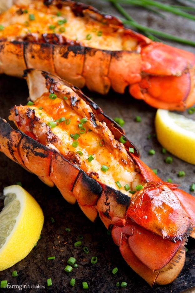 Grilled lobster tails butterflied open and brushed with sriracha butter, garnished with chopped chives