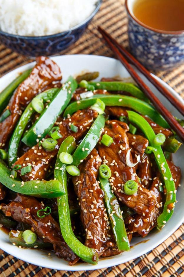 Quick beef and pepper stir fry with thin sliced steak and green peppers in a glossy brown sauce ready to serve at home