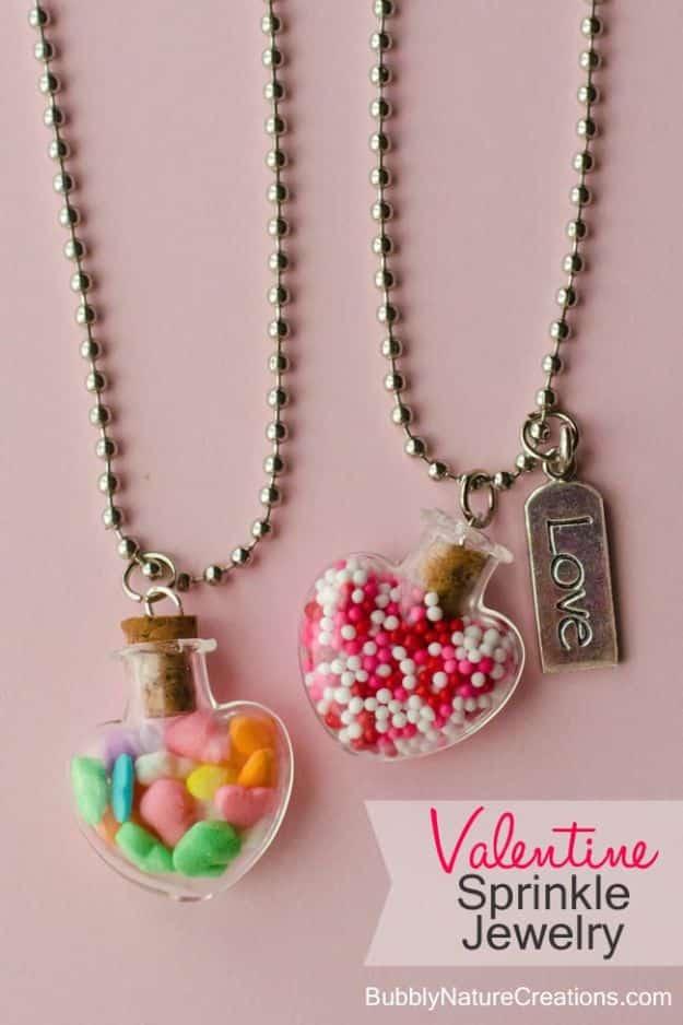 A tiny heart shaped glass bottle necklace filled with colorful sprinkles on a chain, a cute DIY gift