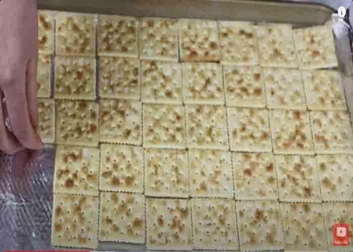 Laying the saltine crackers to the sheet pan