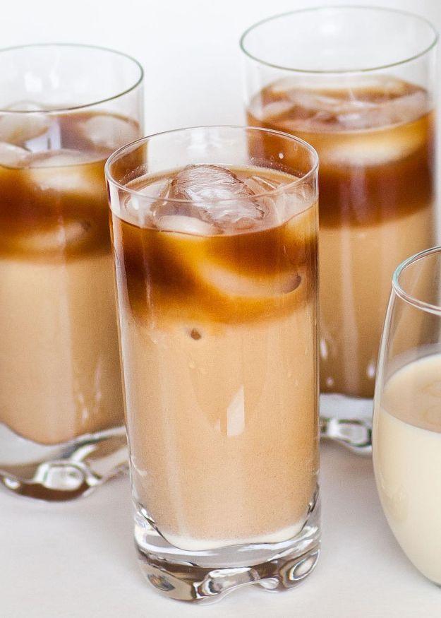 Iced Thai coffee in three tall glasses showing pale condensed milk swirling up through dark chilled coffee
