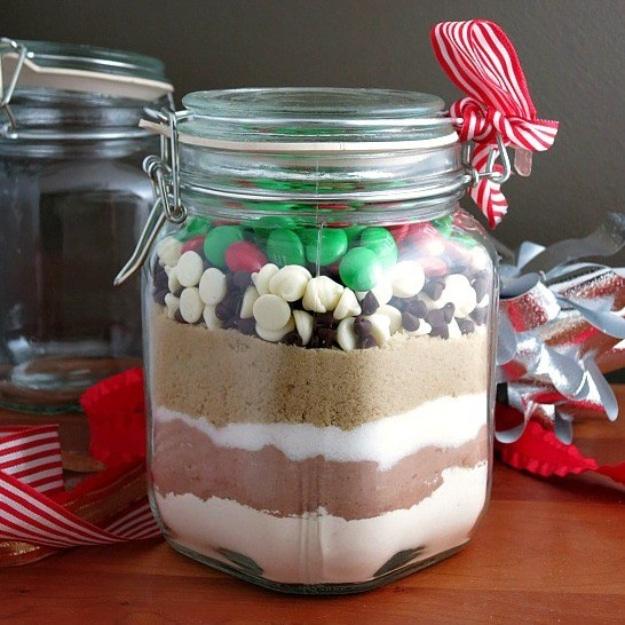 Clamp lid glass jar of candy cookie mix layered with white and dark chocolate chips and colored candies