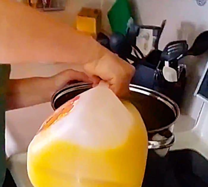 Bring orange juice and sugar to a boil. Stir in creamer until dissolved. Remove from heat and cool to room temperature. Add vanilla extract, vodka, and moonshine. Stir, then jar an