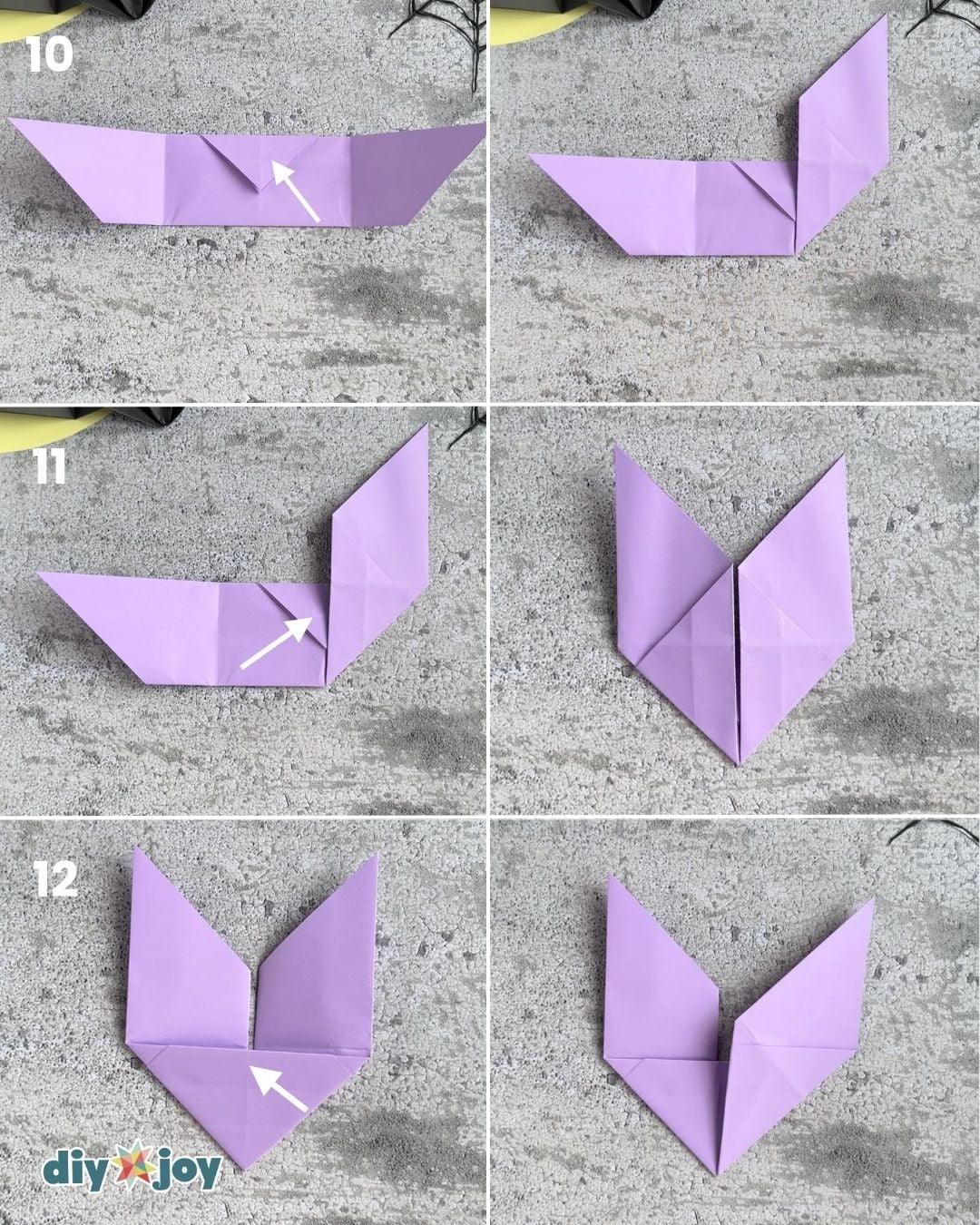 Halloween paper bats step 4, folding the tip to the crease line, a no-scissors classroom craft favorite.