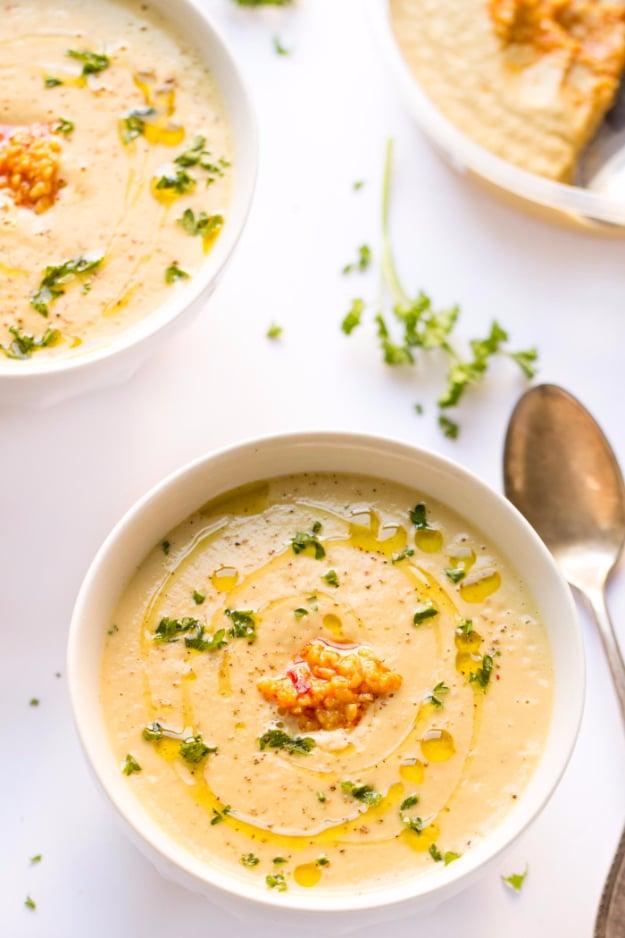 Roasted garlic cauliflower chowder, creamy and thick, in a bowl with a swirl of olive oil on top for a thirty minute dinner