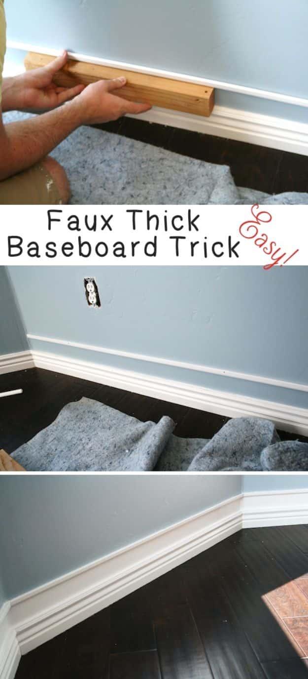 Faux thick baseboard, trim held against a blue wall with a wood spacer, and the finished tall white baseboard