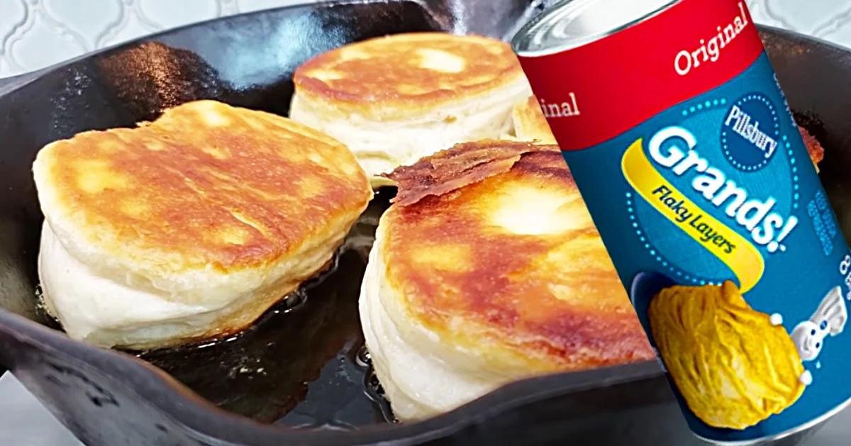 Stovetop biscuits cooked from canned dough in a buttered cast iron skillet with a crisp golden crust