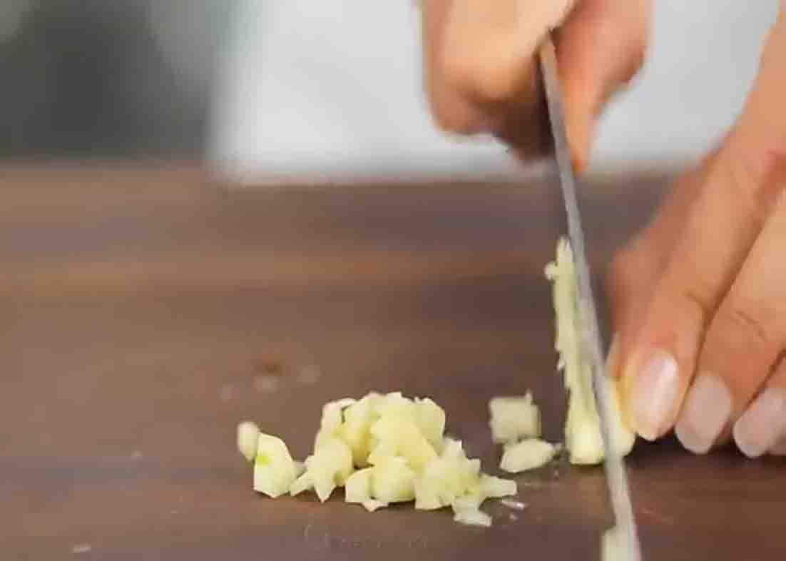 Mincing the garlic for the tuscan chicken