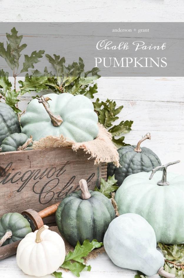 Dry brushed chalk painted pumpkins in muted green tones styled to look like real heirloom pumpkins for fall