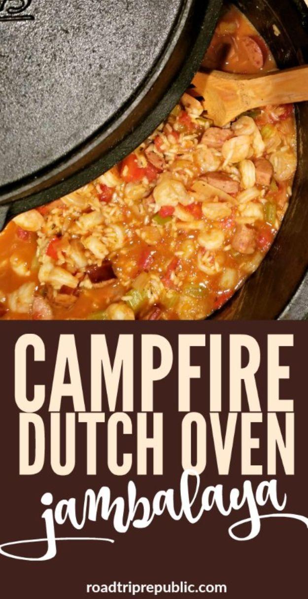 Campfire jambalaya cooked in a dutch oven with sausage, rice and peppers over an open fire while camping