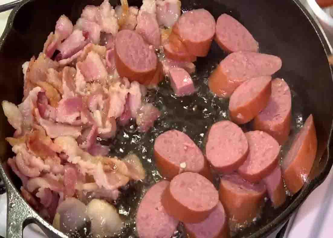 Frying the bacon and sausage