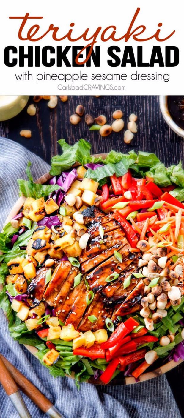 Teriyaki chicken salad in a wooden bowl with sliced glazed chicken, pineapple chunks, red pepper and macadamia nuts