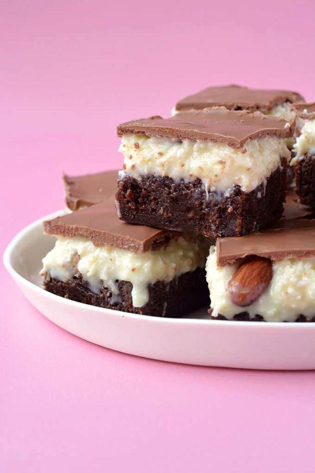 Almond Joy coconut brownie bars showing a dark brownie base, white coconut layer, almonds and chocolate top