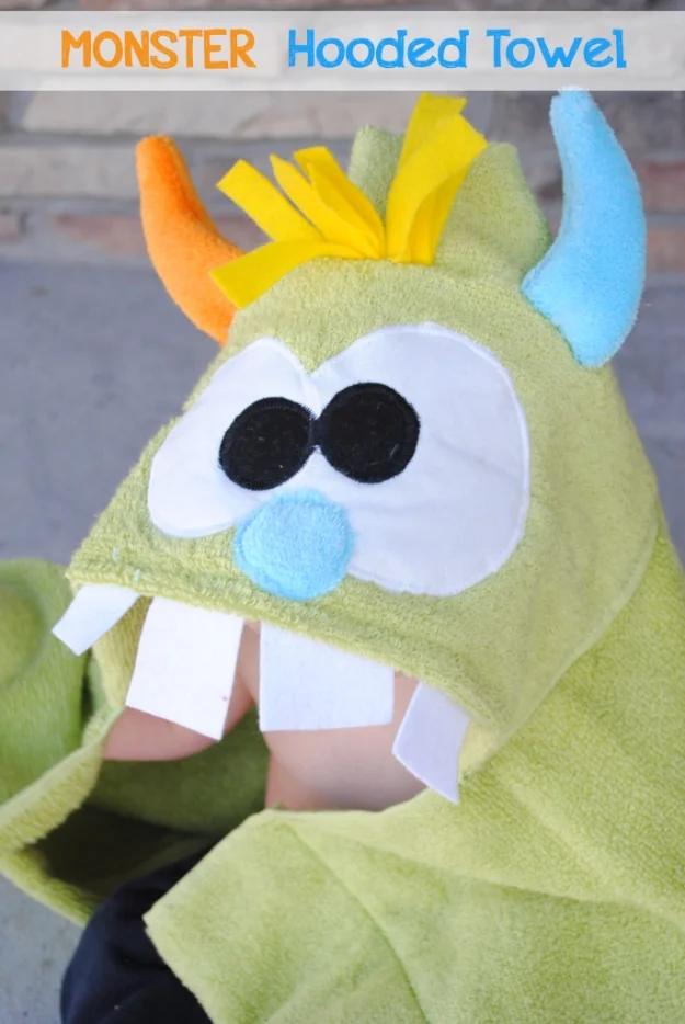Sewing projects for boys monster hooded towel in green terry with felt horns, teeth and big cartoon eyes worn by a child