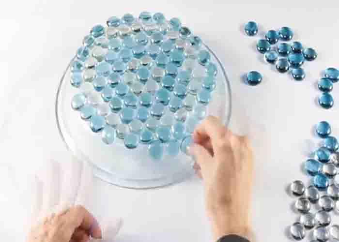 Attaching the glass beads to the pie plate to make the bird bath