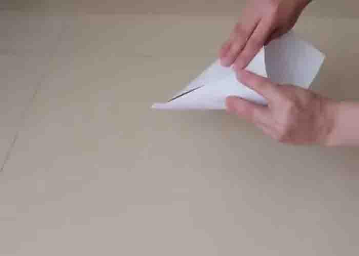 Folding the white paper for the wall Christmas tree