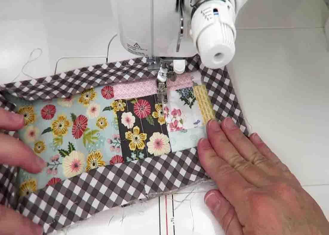 Sewing the binding along the quilted mug rug