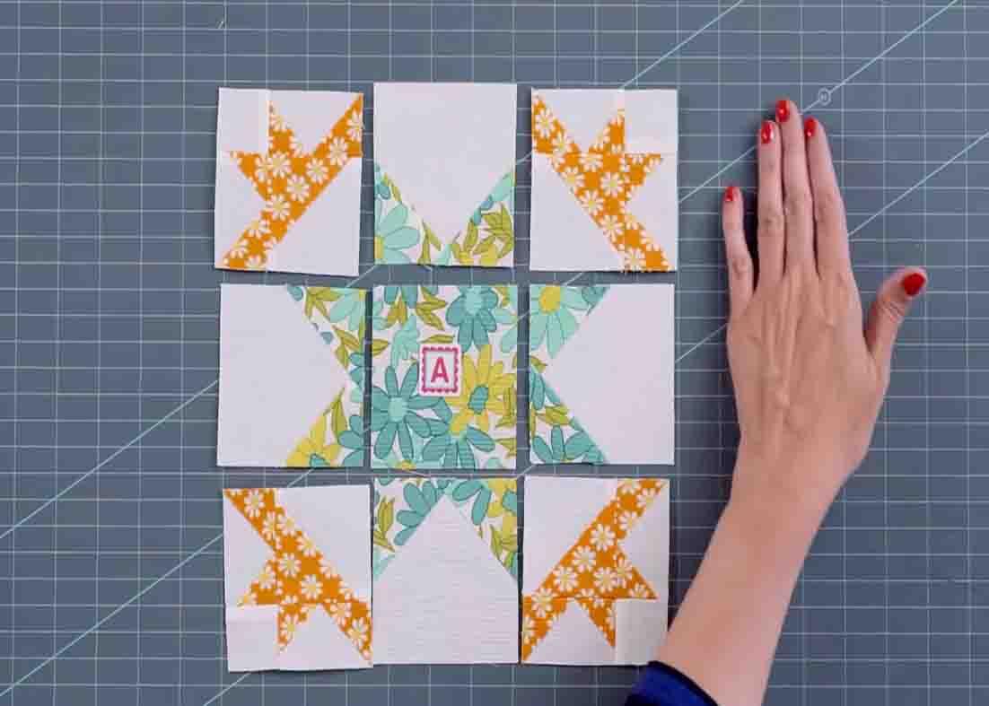 Assembling the blocks together to make the blazing star block quilt
