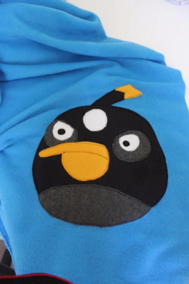 Sewing projects for boys Angry Birds blanket in bright blue fleece with a black bird face appliqued in felt and fleece