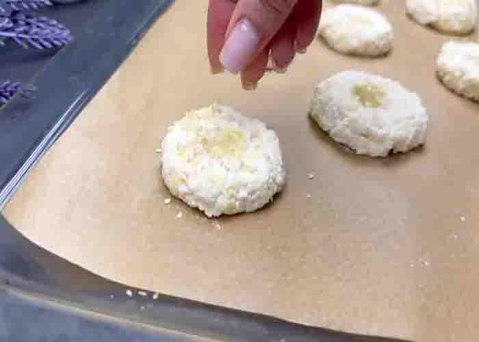 Sprinkling some sesame seeds on the bagels