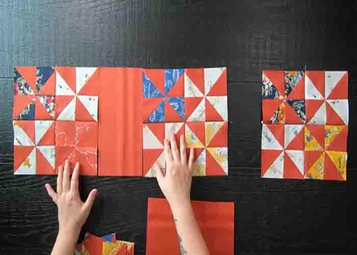 Laying the blocks to complete the painterly pinwheels quilt