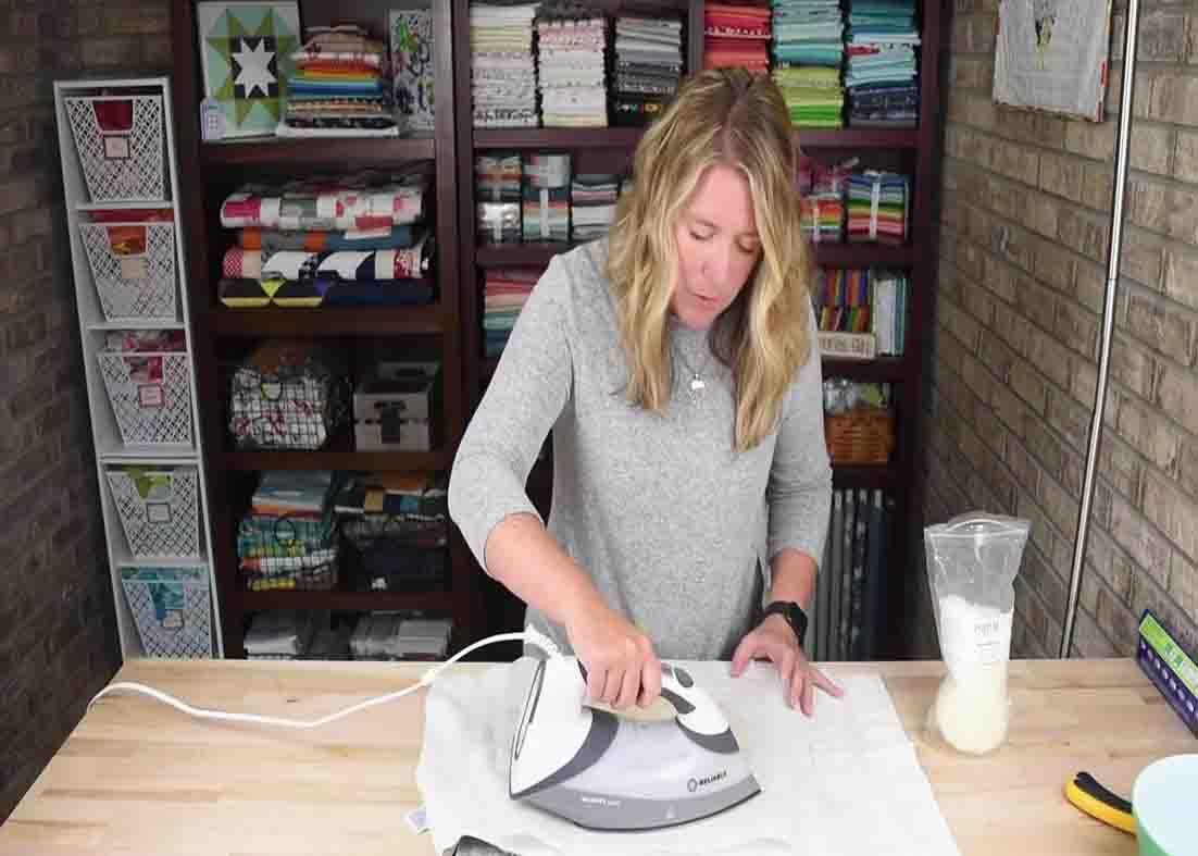 Ironing the fabric to melt the beeswax