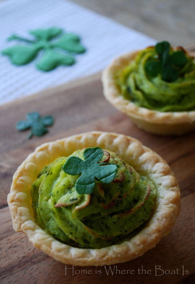 Spinach pesto mashed potatoes piped into small pastry tart shells and topped with a punched spinach clover