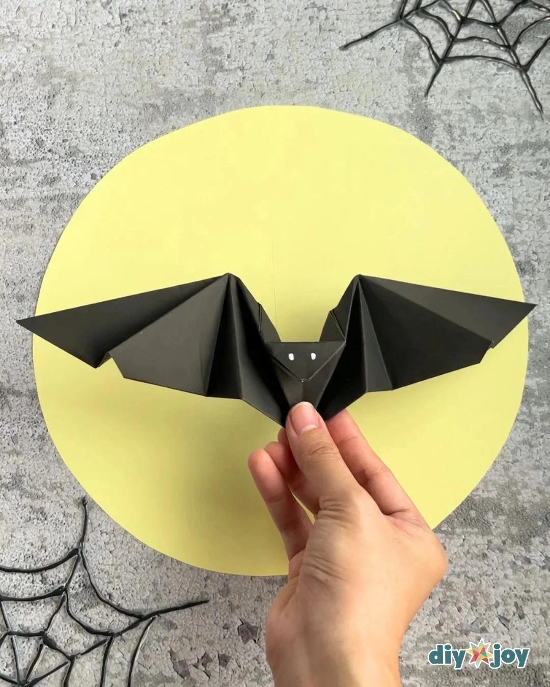 Easy origami bat, a simple paper craft for kids, folded from one square of paper with no glue and no scissors.