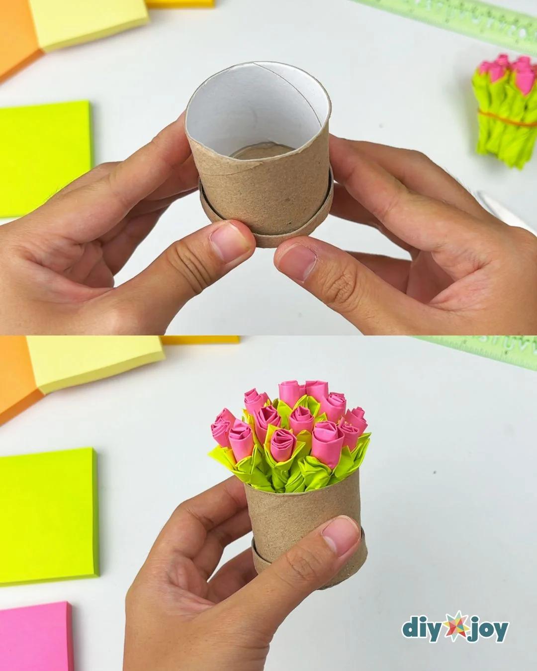 Hands holding an empty cardboard tube vase ready to be filled with handmade Post-it note paper roses