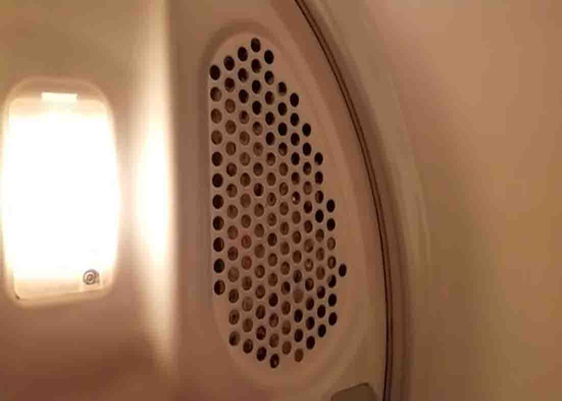 Vacuuming the lint screen at the back to make the dryer working properly again
