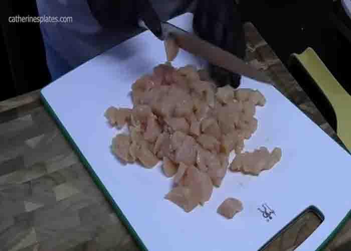 Chopping the chicken for the one-skillet chicken and rice recipe