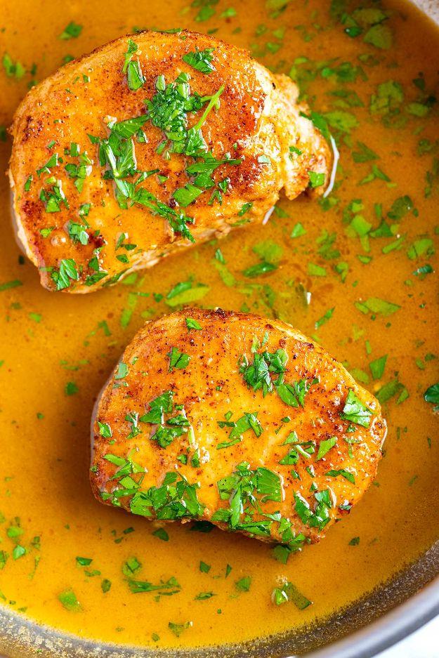 Best juicy skillet pork chops, two golden seared boneless chops resting in a glossy pan sauce with parsley