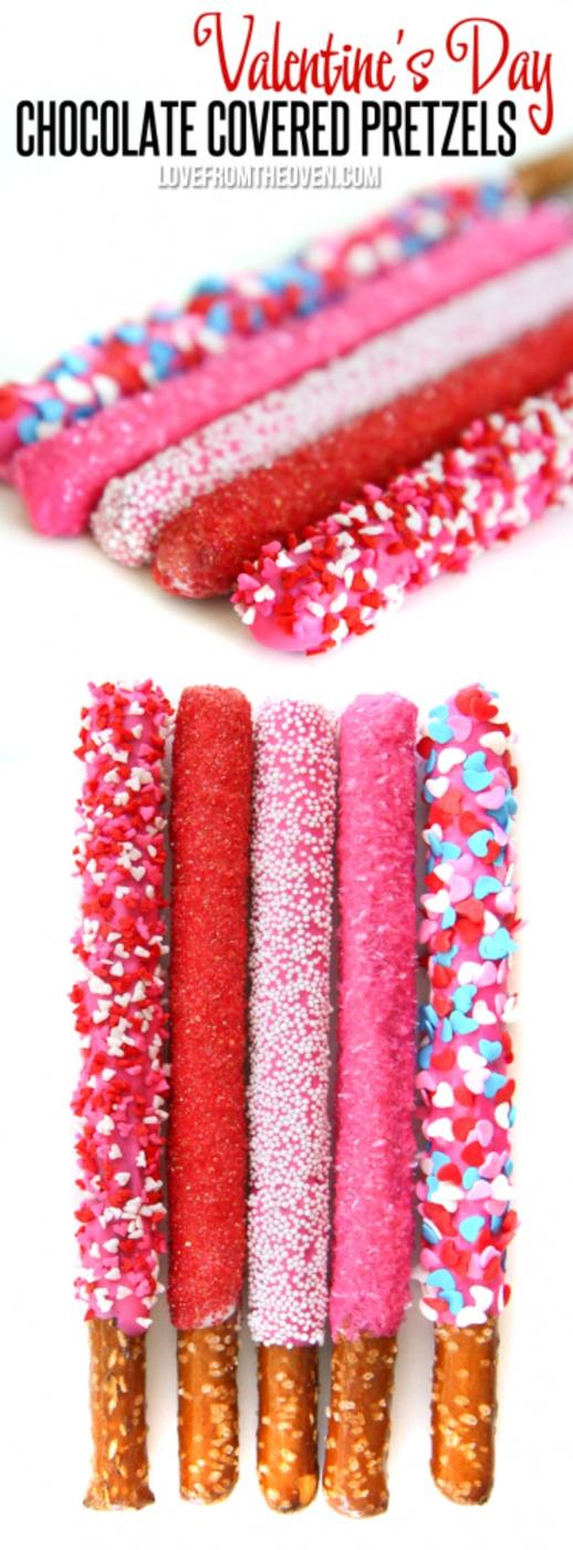 Pretzel rods dipped in chocolate with pink and red sprinkles standing in a jar as a Valentine treat in pink and red