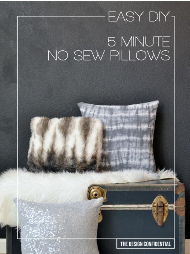 Three no sew pillows in faux fur, grey tie dye and silver sequins stacked on a vintage trunk against a dark charcoal wall
