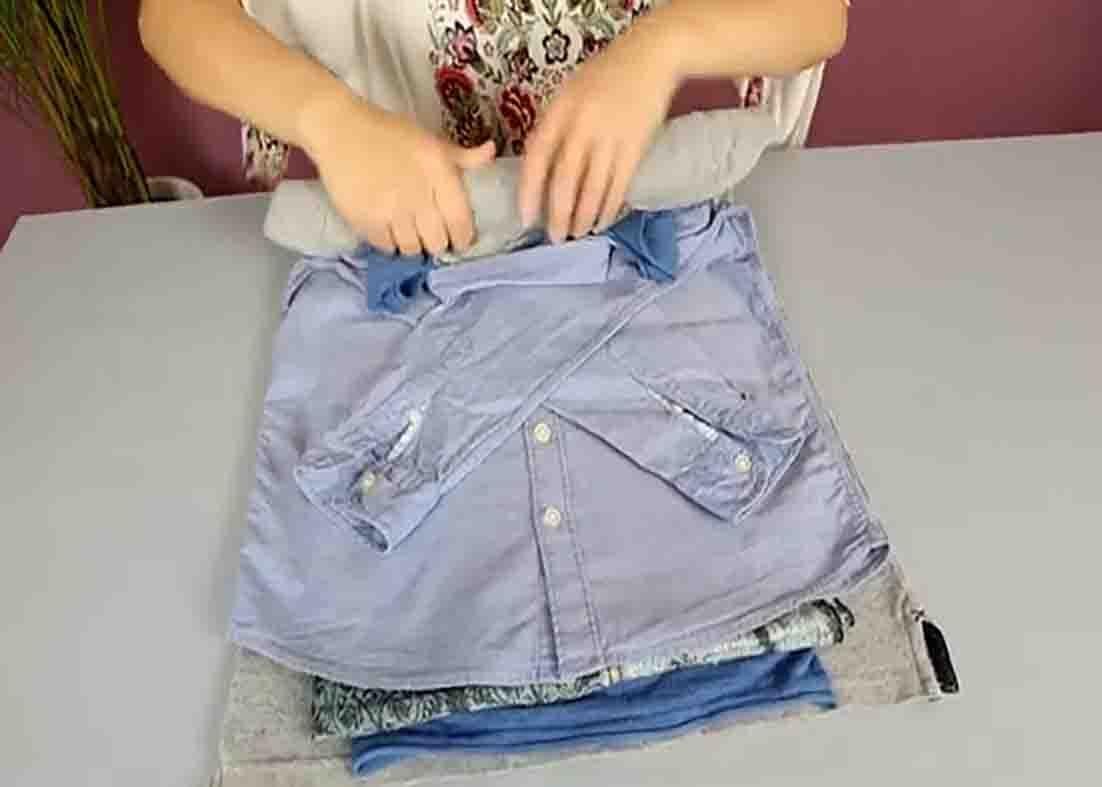 Rolling all the clothes together to avoid wrinkling