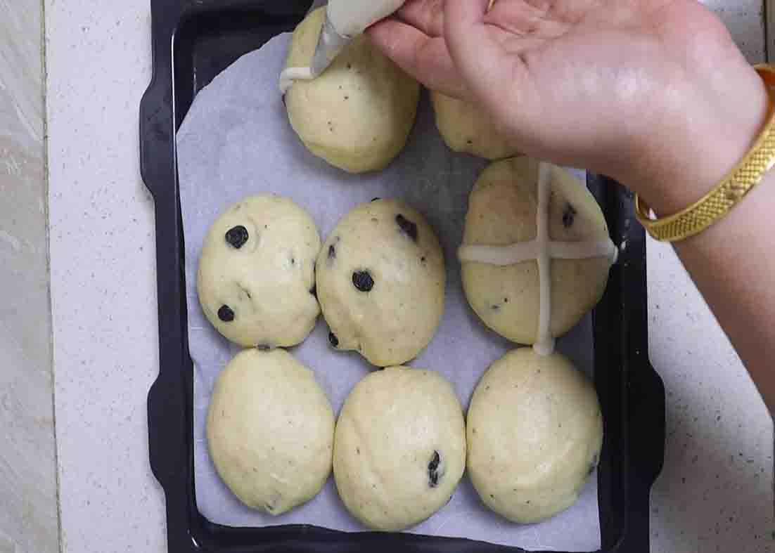 Adding the paste to the top of the buns