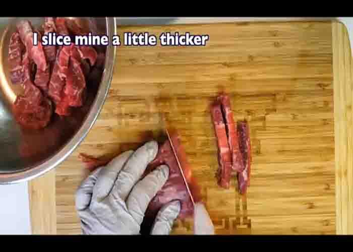Cutting the flank steak into as thinly as possible