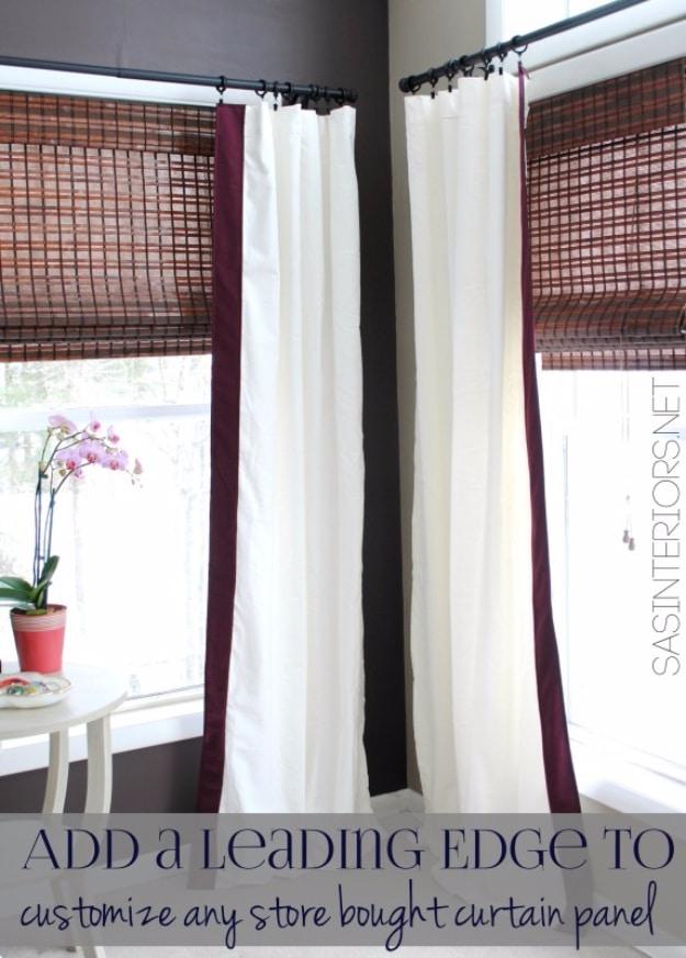 Cream velvet curtain panels with a deep plum leading edge band, hung over woven shades against a dark painted wall