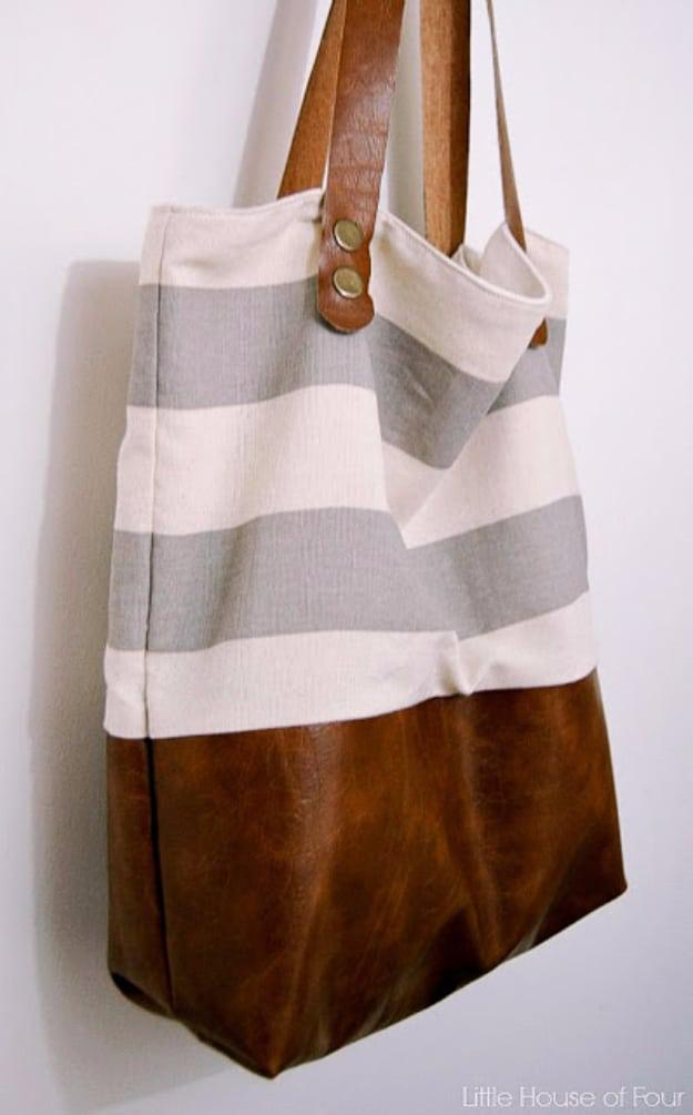 Upright tote with a grey and cream striped canvas top, a cognac leather bottom panel and long leather straps